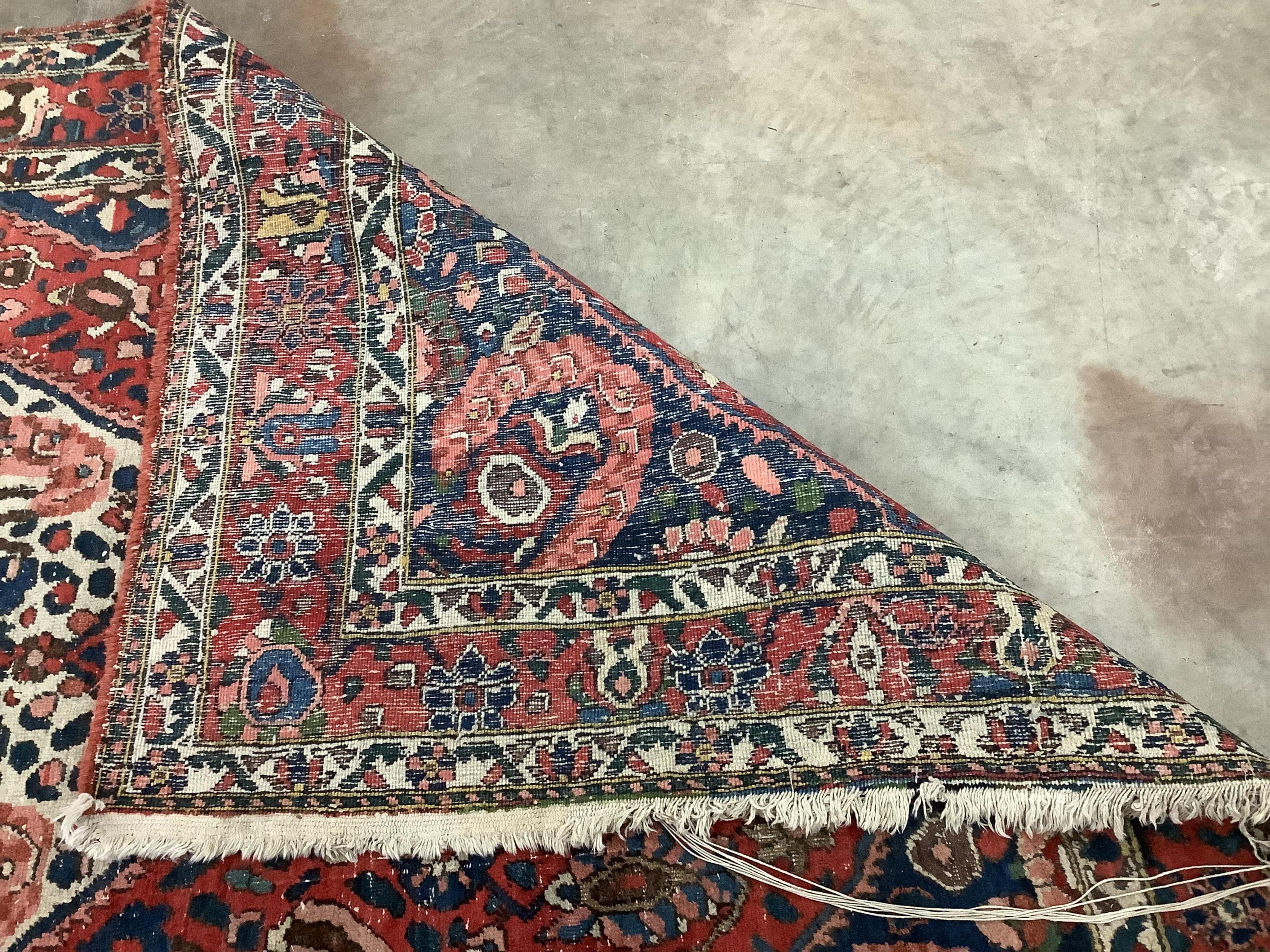 A North West Persian brick red ground carpet, 320 x 178cm. Condition - poor to fair